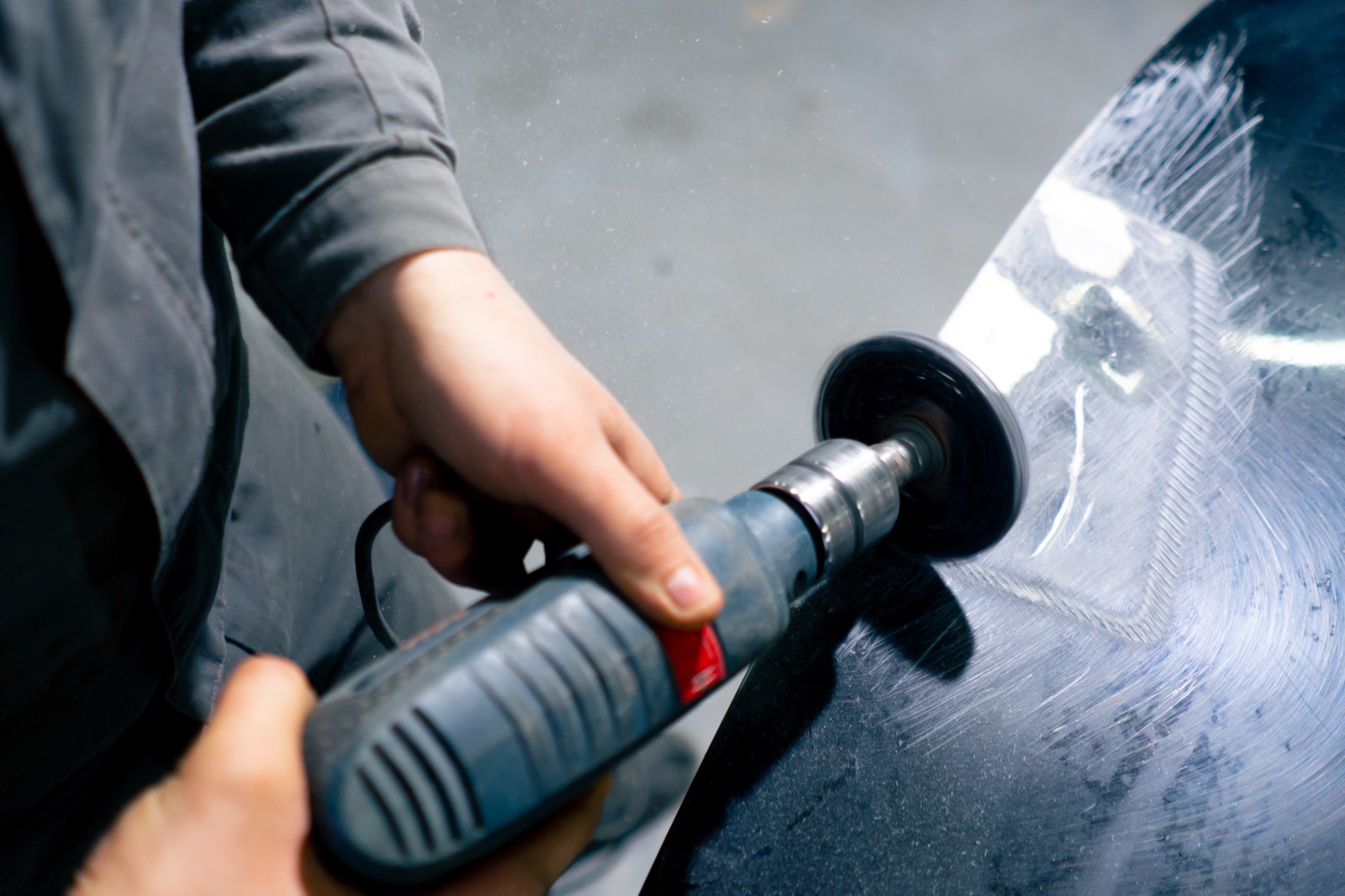 Close-up of paintless dent repair tool work